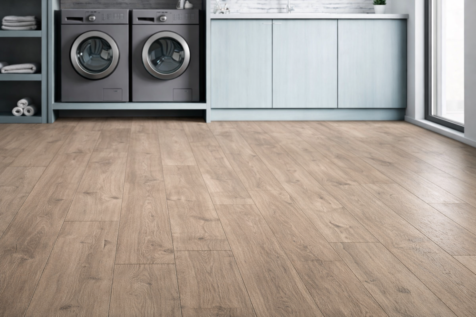 RevWood® waterproof laminated wood flooring installed in a modern Indianapolis laundry room with light wood planks, built-in cabinetry, and front-loading washers, highlighting moisture-resistant flooring for utility spaces.